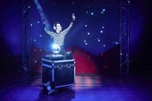 Stephanie Dufresne behind a flight case with a spotlit disco ball on it