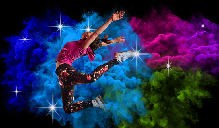 Ivonne Kalter leaping in front of a background of multicoloured clouds