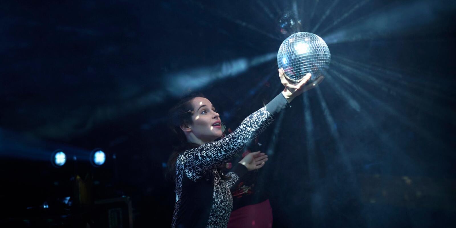 Stephanie Dufresne holding a disco ball in the light