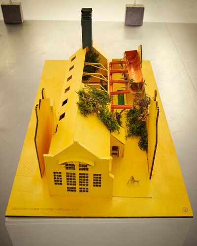 A yellow card model of the CoisCéim building