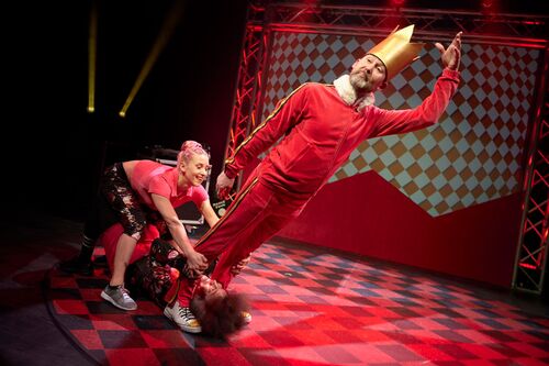 Three dancers in a counter balance on stage