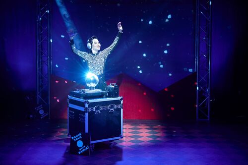 Stephanie Dufresne behind a flight case with a spotlit disco ball on it