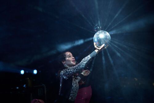 Stephanie Dufresne holding a disco ball in the light