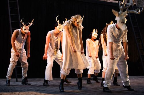 An ensemble in white wearing different animal masks