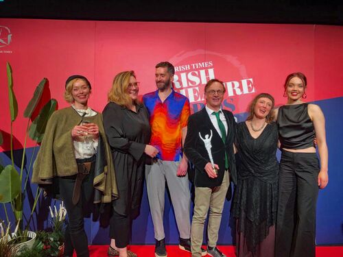 The team of GO TO BLAZES standing in a line at The Irish Times Irish Theatre Awards