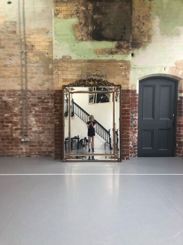 Marion Carriau reflected in the mirror at CoisCéim studio