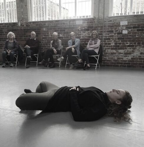 Vittoria Caneva lying on a studio floor with audience in the background