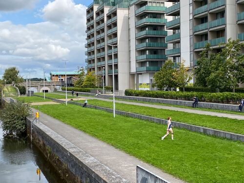 Jessie Thompson crossing the grass at Spencer Dock