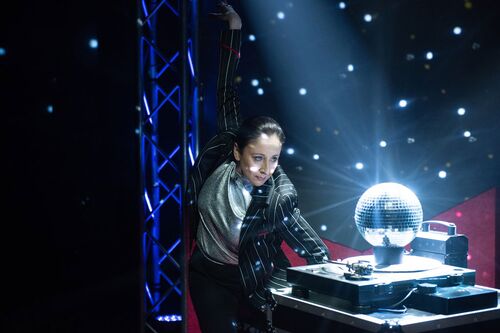 Emma O'Kane looking into a disco ball sitting on a record player