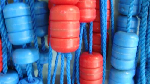 A close up of red and blue pool lane dividers