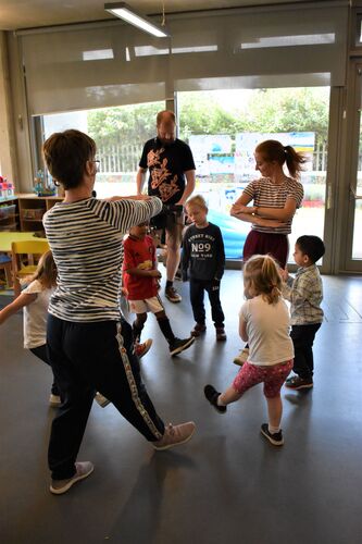 Philippa Donnellan and Olwyn Lyons leading dance with children in a creche