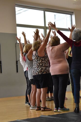 A group of participants in movement in a school hall