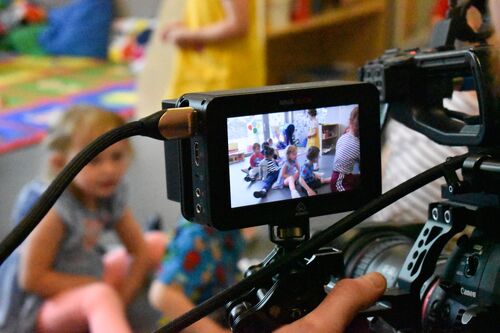 A view through a camera monitor of children during filming