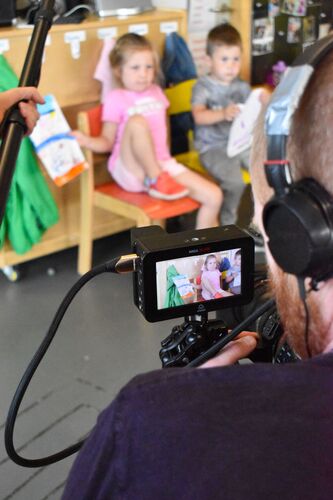 Two children on a camera monitor during filming