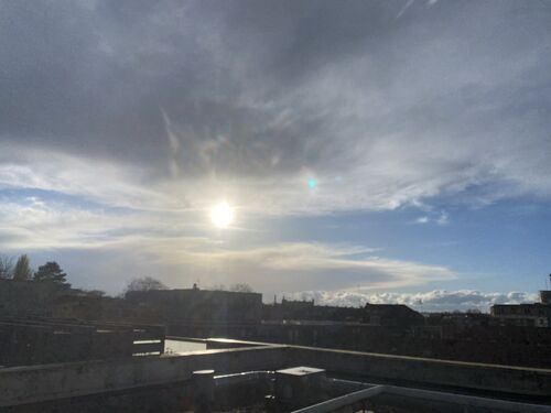 A view of the sun over rooftops