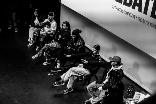 A row of judges seated and pointing to a winner in black and white