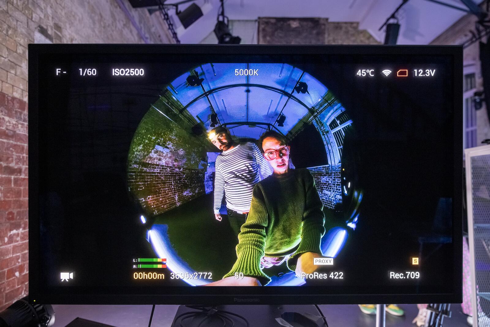 Two people looking at the 3D camera